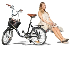 woman sitting next to her bicycle