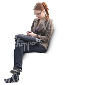 woman sitting and looking at her phone