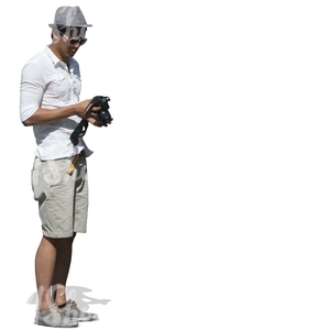 man standing and looking at his camera