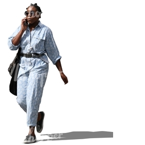 black woman walking and talking on the phone