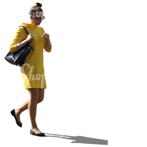 cut out backlit woman in a yellow dress walking