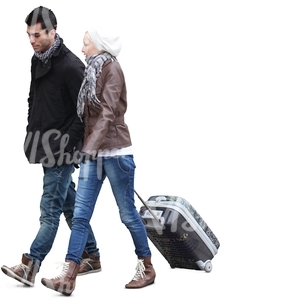man and woman walking and pulling a suitcase