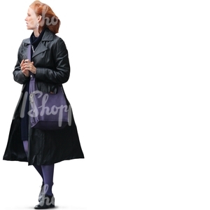 red haired woman in a black coat walking and talking