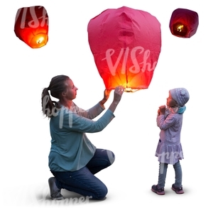 mother and daughter lighting a sky lantern