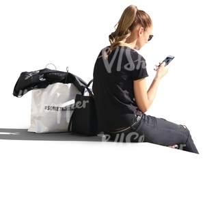 woman sitting and looking at her phone