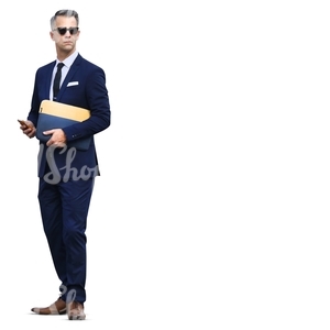 businessman standing with a phone in his hand