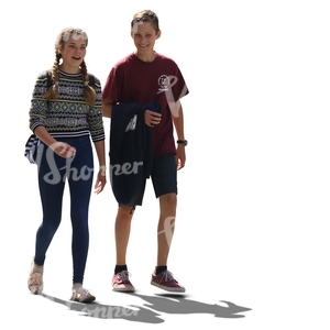 backlit teenage boy and girl walking and talking