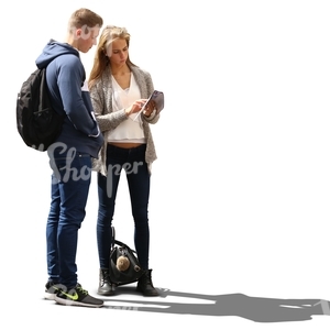 backlit man and woman standing and looking at the map