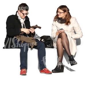 man and woman wearing autumn coats sitting and talking