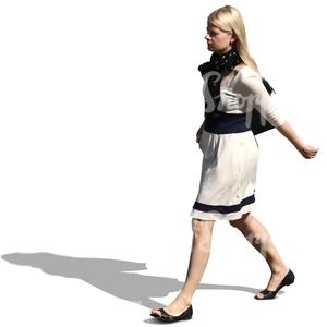 blond woman in a dress walking