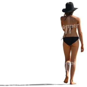 woman wearing a black hat and bikini walking on the beach