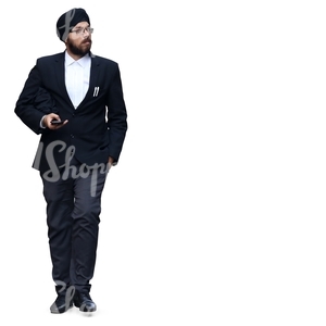 hindu businessman with a turban walking with a phone in his hand