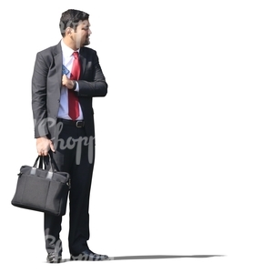 indian businessman in a suit standing with a bag in his hand