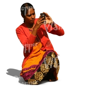 indian woman kneeling and taking a picture