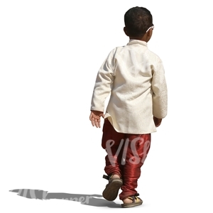 small hindu boy in a fancy costume walking