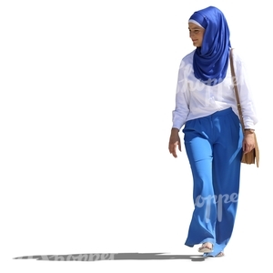 young muslim woman in a blue and white outfit walking