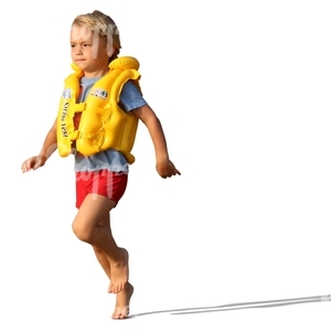 boy in a swim vest running on the beach