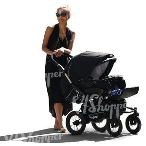 backlit woman walking a baby