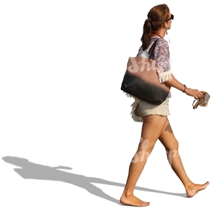 woman walking on the beach and carrying her sandals