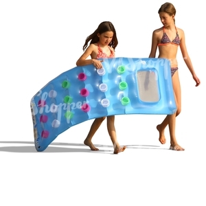 two girls carrying a floatie on the beach