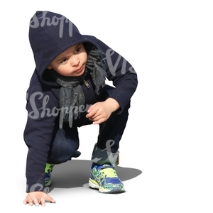 little boy squatting and looking up