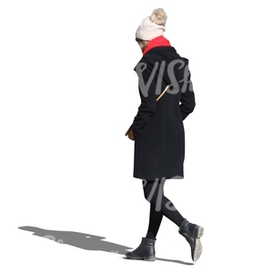 woman wearing a black coat and white hat walking