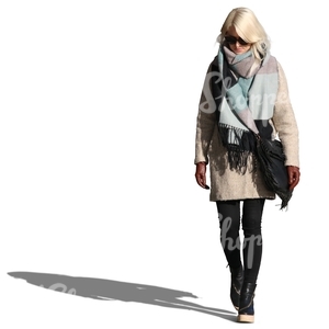 woman wearing a large scarf and coat walking