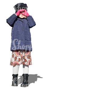 little girl wearing a winter jacket standing in the sunlight