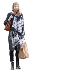 woman with a big scarf and a shopping bag standing