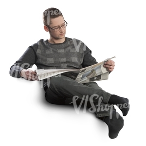 man sitting on a sofa and reading newspaper