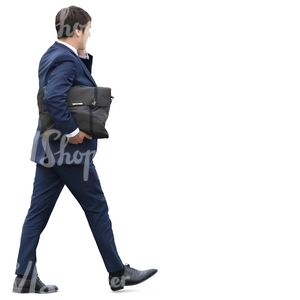 businessman with a briefcase walking and talking on the phone