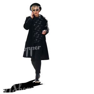 stylish woman in black walking and talking on the phone