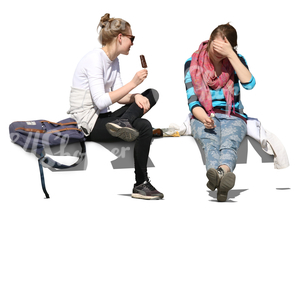 two young women sitting and eating ice cream