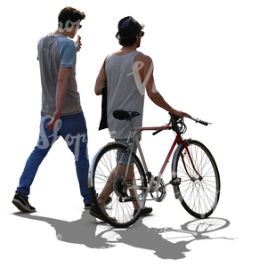 two backlit men walking and one has a bike