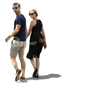 couple walking hand in hand in tree shade