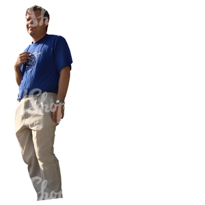 man in white trousers standing on a balcony