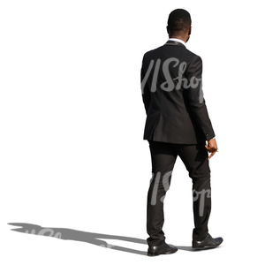 african man in a black formal suit walking