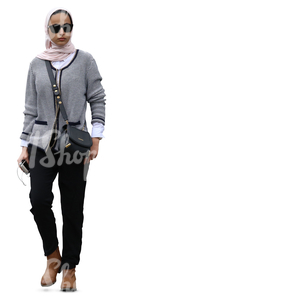 muslim woman with sunglasses walking in ambient light