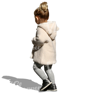 small girl with a beige cardigan walking on the street