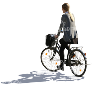 backlit woman riding a bike