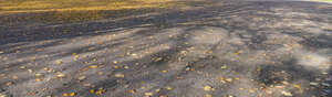 gravel and pavement mixed ground with long autumn shadows