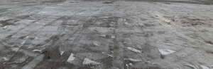 field of asphalt covered with melted ice and snow