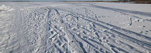 white snow with tyre tracks and footprints