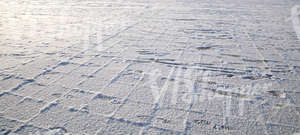 snow-covered pavement with footprints