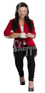 woman sitting at a cafe table and drinking coffee