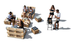 cut out group of young people having a barbeque party seen from above