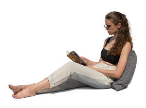 cut out woman sitting on a sofa and reading a book