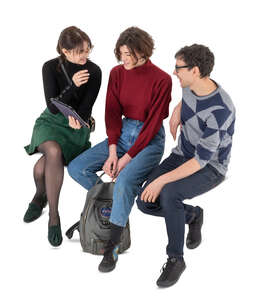cut out group of three friends sitting and talking seen from above
