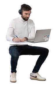 man working at a desk with computer