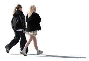 two young backlit women walking